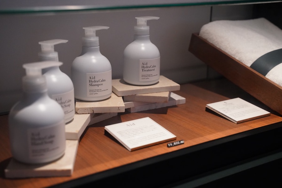 A row of white hotel toiletry bottles