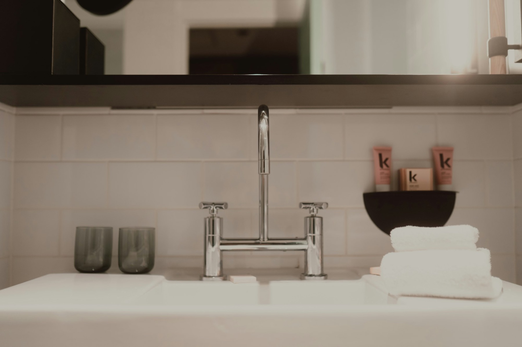 A hotel bathroom vanity set with guest amenities